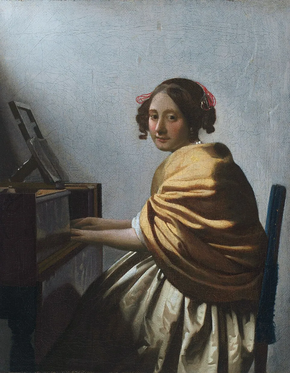 A Young Woman Seated at the Virginals